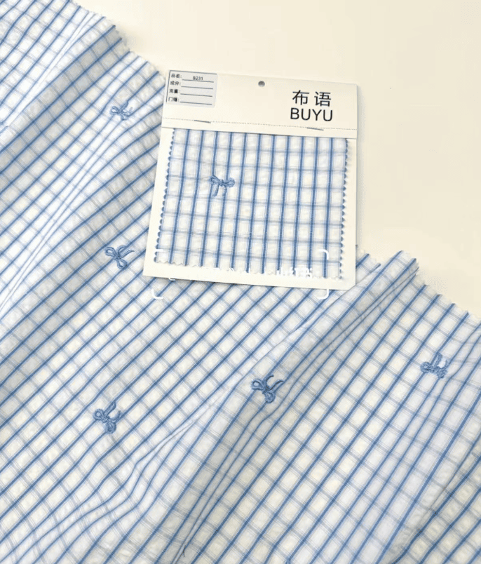 Fabric swatches and children's garment development notes.